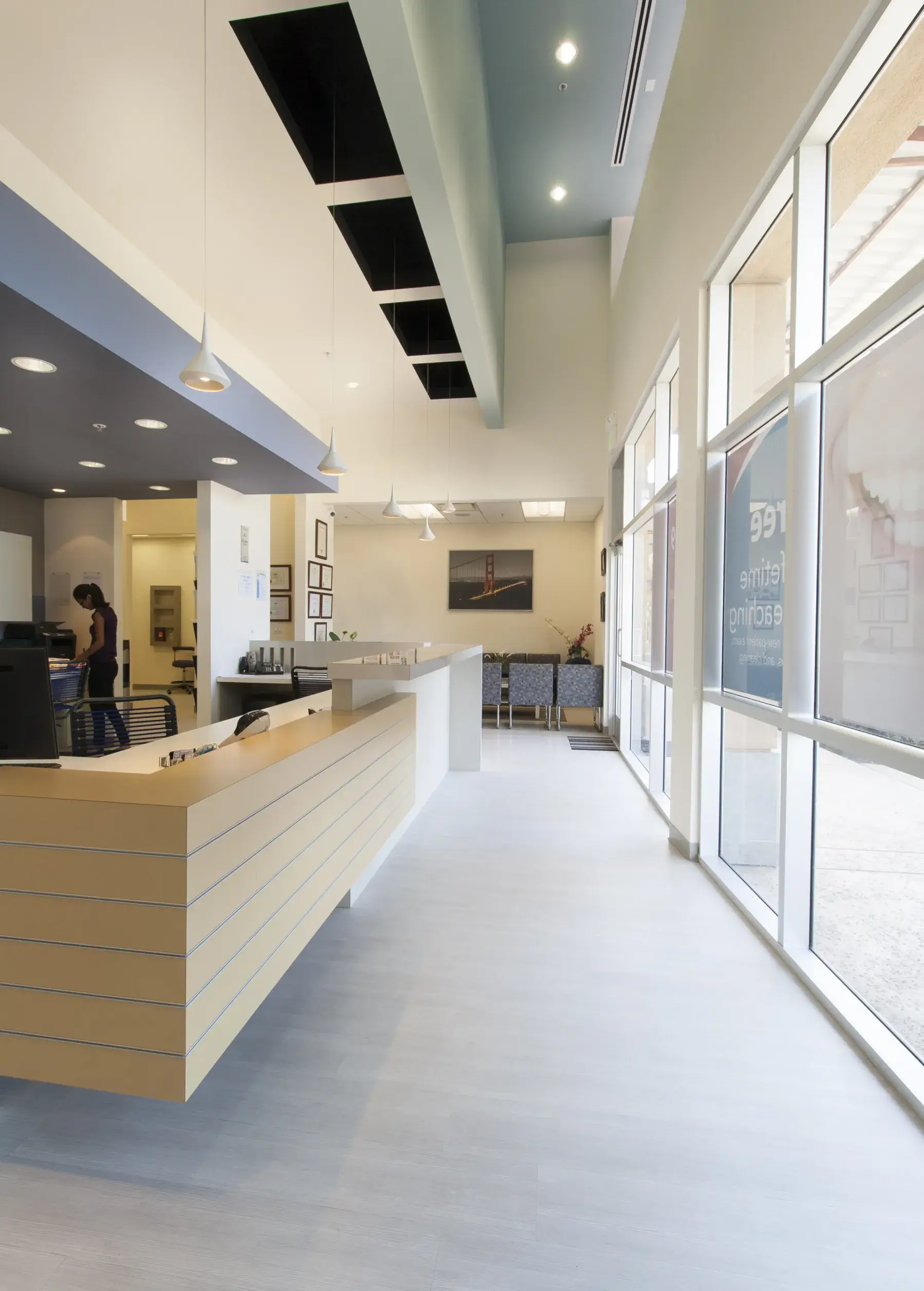 A large room with a long counter and lots of windows.