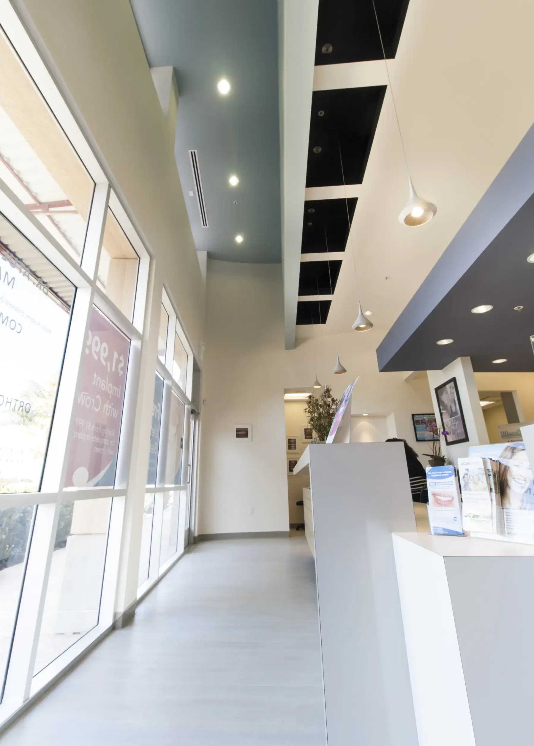 A store front with large windows and a white counter.