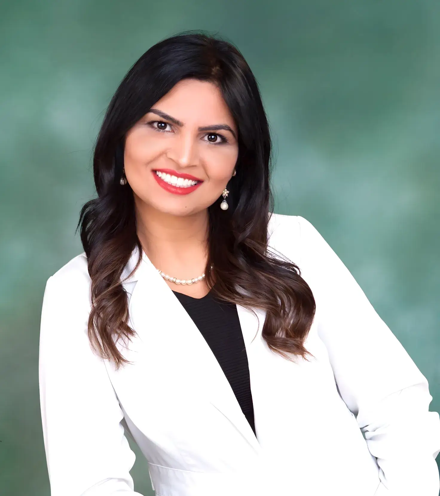 Dr. Rupinder Purewal headshot in a white suit posing for a picture.